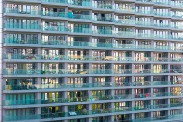 Balconies glass modern building. Residential and inhabited with household items apartment building. Front view close up.