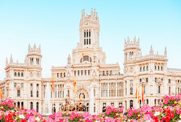 Spain, Madrid - Madrid City Hall building on Cibeles Square, flower garden in the foreground.