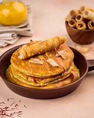 Saffron Pancake served in wooden board isolated on background top view of cafe baked food