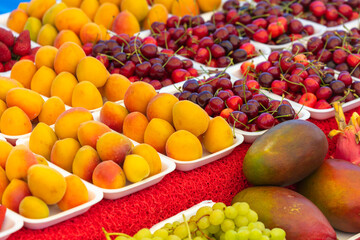 Fresh apricots, cherries on the counter in the market