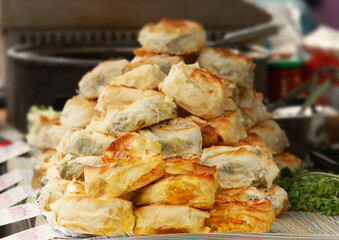 Burek, savoury stuffed phyllo rolls, a Balkan speciality, on display at a stall in Prague farmers street market.