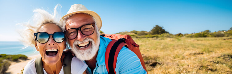 Senior couple taking a selfie during a hike. Traveling and exploring the world after retirement or in a mature age. Shallow field of view.