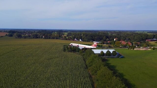 Magic aerial top view flight 
II-62 airplane on ground. hilly summer fields Brandenburg Germany summer 23. panorama overview drone
High quality 4k cinematic footage