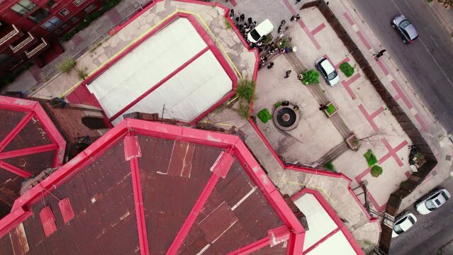 Tilt down establishing of a group of people waiting to enter the back of the Basilica of the Savior, part of the structure's ambo. Santiago Chile