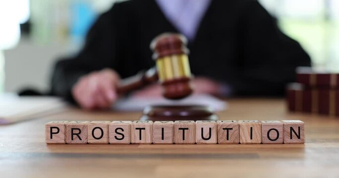 Word prostitution and judges knocking with wooden gavel. Law on prostitution and world sex tourism