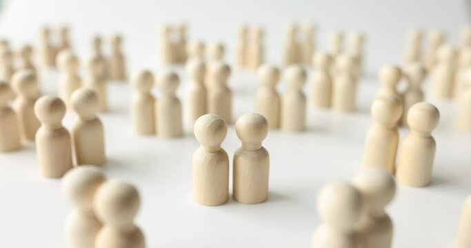 Many pairs of female and male wooden figurines of people on white background. Finding a partner for love relationship