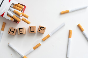 Broken cigarettes and word Help. Concept image.