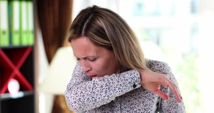Unhappy woman coughs and feels unwell. Sick young woman suffering from respiratory diseases and flu