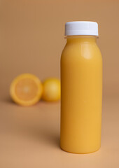 Orange Juice Photography Of a Orange Juice Bottle With Some Orange Slices in the Background on a Seamless Orange Colored Background