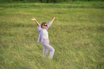 Senior woman, at ease in nature with wildflowers, showcasing the tranquility achievable with secure financial planning