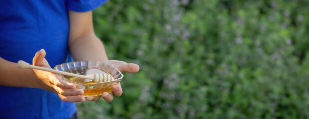 boy eats honey in nature, homemade honey. Selective focus