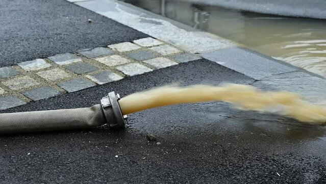 Pumping water in the flooded street after heavy rain and storms