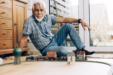 Senior Man Playing With Model Train