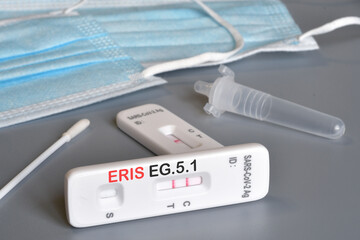 SARS-CoV-2 antigen test kit for self testing with positive result with text ERIS EG.5.1 on grey...