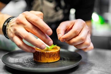 chef decorated chocolate fondant cake with ice cream and caramel