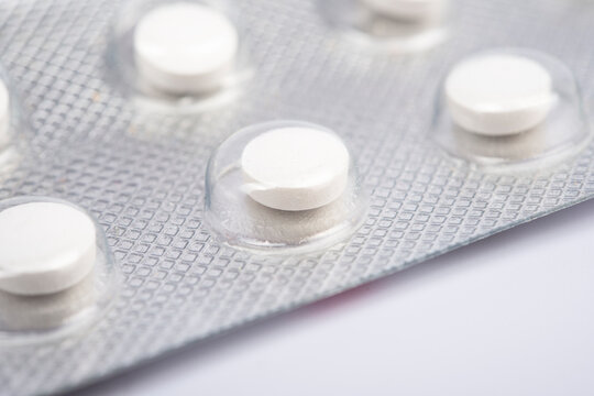 Macro shot of white pills` set isolated on white back-round