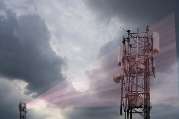 Cellular antenna sends radiation to another antenna. Mobile communication, global network, data transfer under a cloudy sky.