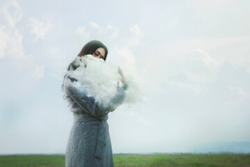 woman gently hugging a cloud in the outdoors, abstract concept