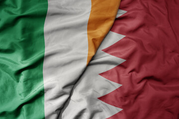 big waving national colorful flag of ireland and national flag of bahrain .