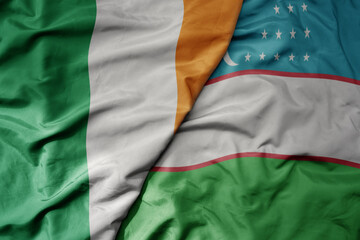 Obraz premium big waving national colorful flag of ireland and national flag of uzbekistan .