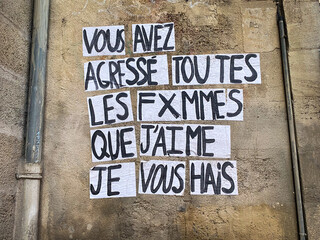 Protest poster against domestic violence and femicide stuck on a wall saying "you assaulted every woman I know I hate you" in french in Paris