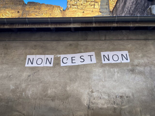 Protest poster against domestic violence and femicide stuck on a wall saying 