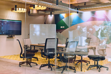 In the contemporary setting of an empty modern glass startup office, the space exudes a sleek and innovative atmosphere, ready to be filled with the potential of entrepreneurial endeavors