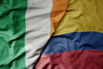 Obraz premium big waving national colorful flag of ireland and national flag of colombia .