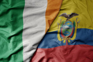 big waving national colorful flag of ireland and national flag of ecuador .