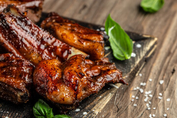 sliced barbecue pork ribs on a wooden background. banner, menu, recipe place for text, top view