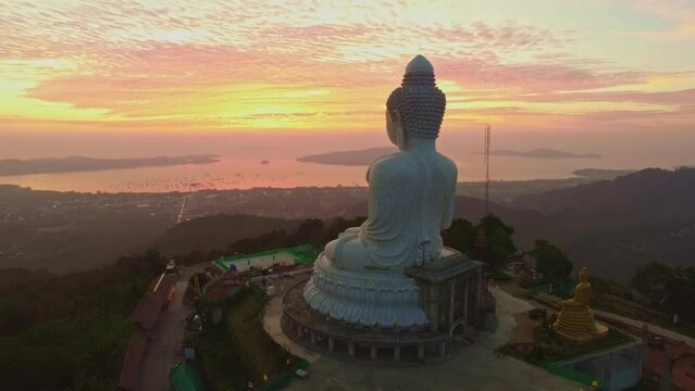 .aerial view stunning cloud in twilight infront of Phuket big Budha..The sun's rays illuminate the Buddha's serene making it .stand out against the backdrop of the cloudy sky and creating a stunning 