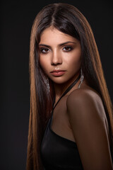 Fototapeta premium Portrait of a young brunette girl with exquisite beautiful makeup