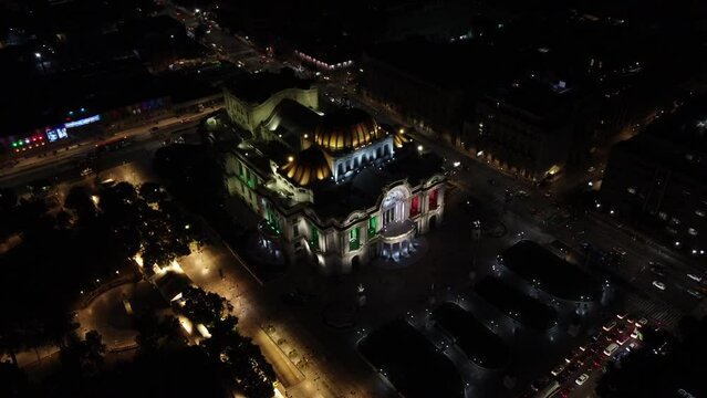 Dusk falls over the Palacio de Bellas Artes in Mexico City. with the mexico flag colors drone view