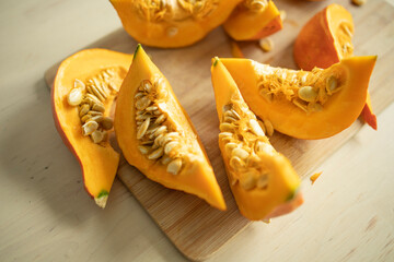 pieces of pumpkin on a wooden surface. Diet, proper nutrition, pumpkin benefits, vitamins all year round, rich harvest