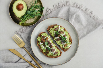 Avocado toast  with mushrooms, feta cheese and microgreens