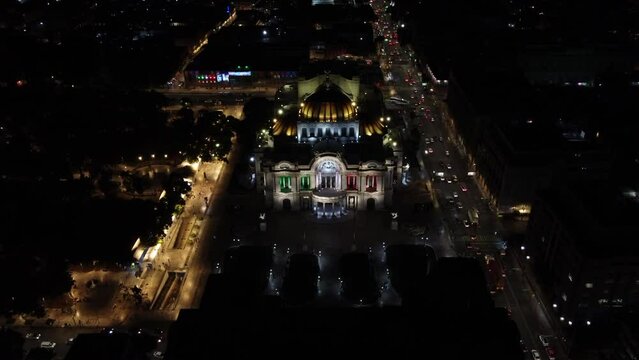 Dusk falls over the Palacio de Bellas Artes in Mexico City. with the mexico flag colors drone view