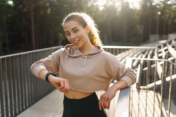 Fitness woman doing sports outdoors in an urban environment. A sports woman in special clothes does exercises. Active lifestyle, training. Lifestyle.