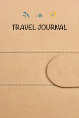 close-up of a travel journal cover featuring three small logos: a plane, a camera, and a compass. The logos add a touch of adventure and exploration to this beautifully crafted journal