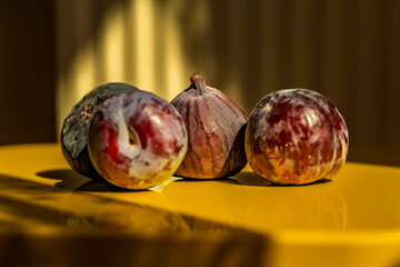 Black fig fruit with yellow background