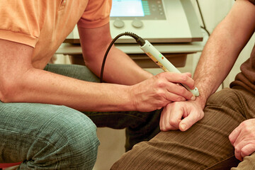 Laser therapy  on wrist - 645297738