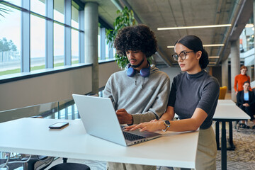 In a contemporary corporate setting, a diverse team of young business experts, including an African American man, collaboratively tackles business challenges with their colleagues embodying innovation