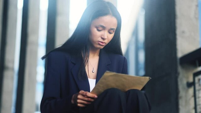 Worried young businesswoman checking mail open envelope and reading bad negative news work result rejection letter feeling disappointed at business centre Defeat Loss Disappointment concept