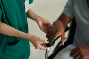 Oxymeter device on finger of sick patient