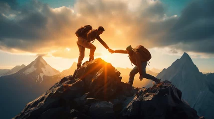 Foto op Plexiglas Close-up of Hiker helping friend reach the mountain top © IBEX.Media
