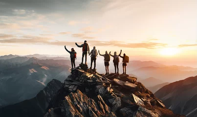 Tuinposter A group of friends holding hands near the summit of a mountain, symbolizing teamwork and collective achievement © Debi Kurnia Putra