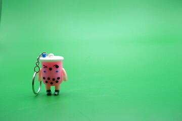 cute key chain isolated on green background.