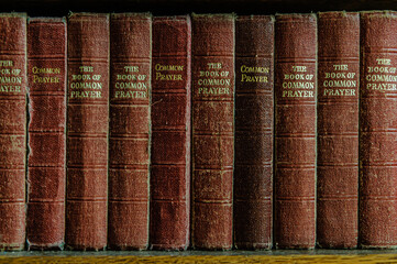 Row of the Book of Common Prayer on a shelf in a church - obrazy, fototapety, plakaty