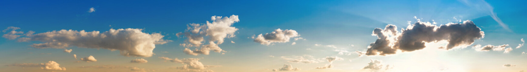 Wide panorama of blue sky with clouds on a sunny day