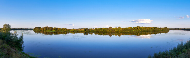 Fototapeta na wymiar Panoramic landscape of a river on a clear summer day
