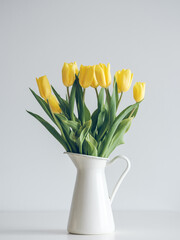 Fresh tulip flowers in vase on table